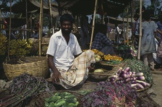 BANGLADESH, Chittagong, Sylhet, Vegetable vendor in marketplace.