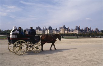 FRANCE, Fontainebleau, Tourist horse and cart travelling through grounds