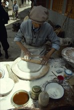 CHINA, Yunnan Province, Dali, Man making moon cakes.