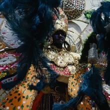 TRINIDAD, Carnival, Carnival dancer wearing brightly coloured extravagant costume.