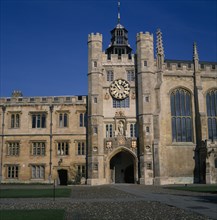 ENGLAND, Cambridgeshire, Cambridge, Trinity College exterior facade and clock tower.