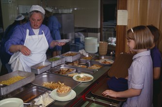 FOOD, Cooked, Eating, School children with dinner lady serving in the canteen