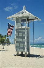USA, Florida , Fort Lauderdale , Lifeguard post on beach with American Stars and Stripes flag.
