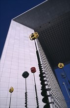 FRANCE, Ile De France, Paris, The Grand Arch at La Defence with colourful sculptures in front of it