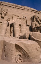EGYPT, Abu Simbel, Three of the four giant statues of Ramesses II at the entrance of the Great