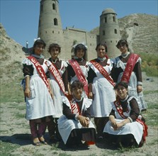 TAJIKISTAN,  Hissar, "Girl students, traditional dress, graduation sashes "