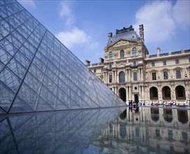 FRANCE, Ile de France, Paris, Louvre.  Cour Napoleon and glass pyramid reflected in water