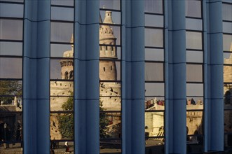 HUNGARY, Budapest, Fishermen’s Bastion reflected in the windows of the Hilton Hotel