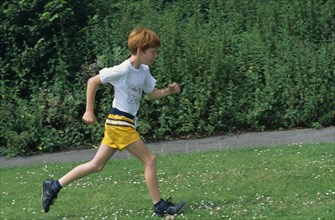 10028025 CHILDREN Leisure Running Young boy running on grass.