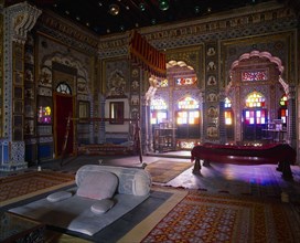 INDIA, Rajasthan, Jodhpur, Meherangarh Fort.  Interior of the bedroom of the Maharajah with light