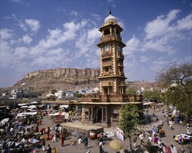 INDIA, Rajasthan, Jodphur, Sadar Market.  Clock tower surrounded by stalls and traders with