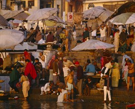 INDIA, Uttar Pradesh , Varanasi, The ghats at dawn with crowds of people washing in the River