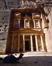 JORDAN, Petra, The Treasury.  Porticoed entrance carved in pink rock with camel lying down in