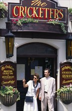 ENGLAND, East Sussex, Brighton, Couple leaving the Cricketers pub.