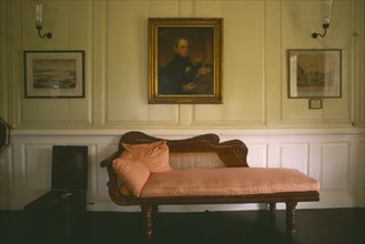 WEST INDIES, Antigua, Governor’s Mansion, Interior with chaise-longue and paintings