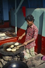 BANGLADESH, Khulna, Barisal, Cooking breads outside restaurant.