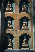 CHINA, Beijing, Summer Palace, Detail of  wall statues with the heads missing from all but one