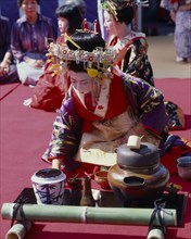 JAPAN, Honshu, Kyoto, Woman in Court costume preparing the Tea Cermony