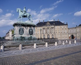 DENMARK, Zealand, Copenhagen, Amalienborg Royal Palace. Statue of man on horseback and brick paving
