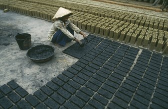 ARCHITECTURE, Vietnam, Hoi An, Brick production worker laying out newly made bricks