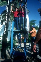 CUBA, Hemmingway Marina, Marina Fishing Contest with men hanging their catch from a platform for