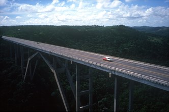 CUBA, Matanzas, View over bridge with one or two cars crossing