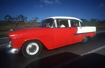 CUBA, Pinar Del Rio, Transport, Old red and white coloured 1950 s US car
