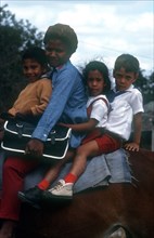 CUBA, People, Woman and three children sitting on horseback