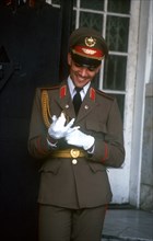 CUBA, Havana, Man in military uniform putting on white gloves