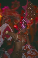 CUBA, Havana Province, Havana, Tropicana Club female dancer in pink costume in front of other