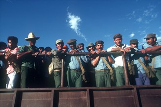 CUBA, Rio Cauto, Militia men on the back of a truck