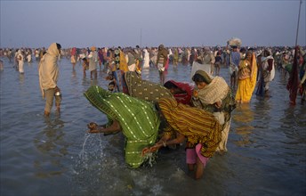 INDIA, River Ganges, Pilgrims bathing in the River ganges during the Ganga Sagar Festival.