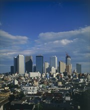 JAPAN, Honshu, Tokyo, View over city rooftops with high-rise buildings and skyscrapers in the