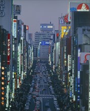 JAPAN, Honshu, Tokyo, View down the Ginza at night busy with people and traffic