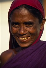 BANGLADESH, Khulna, Barisal, Head and shoulders portrait of smiling woman.