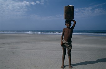 INDIA, Goa, Colva Beach, Young boy from Karnataka selling drinks on the beach