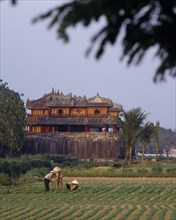 VIETNAM, Central, Hue, "The Citadel, Ngo Mon Gate, workers tending crops in field, trees "