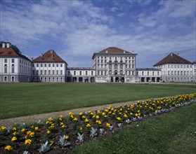 GERMANY, Bavaria, Munich, Nymphenberg Palace. View over lawns and border of yellow marigolds