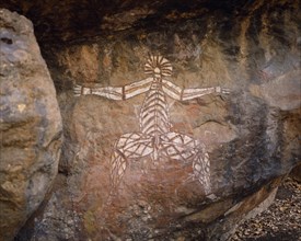 AUSTRALIA, Northern Territory, Kakadu National Park, Aboriginal rock painting onto red and black