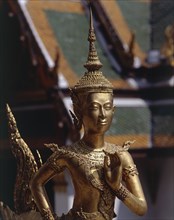THAILAND, Bangkok, Wat Pra Keo close up of a golden statue with jewelled collar and head-dress