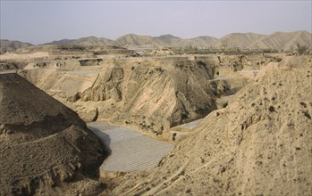 CHINA, Gansu, Loess scenery near the Yellow River showing farming under polythene tunnels