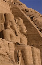 EGYPT, Abu Simbel, Two of the giant statues of Ramesses II at the entrance to the Great Temple