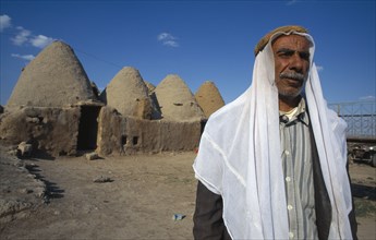 TURKEY,   , Harran, Old man stands outside beehive mud houses