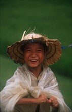 VIETNAM, General, "Smiling child wearing straw hat.  Head and shoulders, facing camera. "