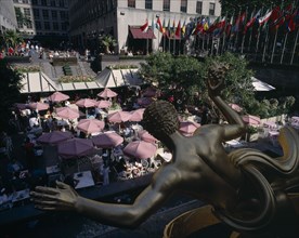 USA , New York State, New York, "Rockefeller Centre, open air cafe with pink umbrellas and gold