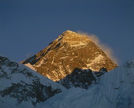 NEPAL, Everest National Park, Mount Everest peak bathed in golden evening sunlight