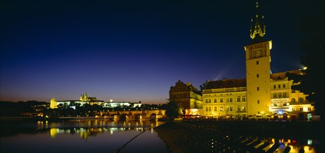 CZECH REPUBLIC, Stredocesky, Prague, View across River Vltava to city at night