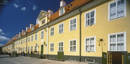 LATVIA,  , Riga, Swedish Gate. Row of bright yellow terraced houses
