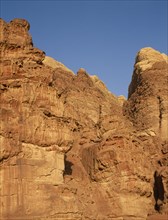 JORDAN, Wadi Rum, Rock face in golden sun shine