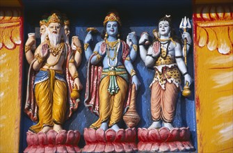 INDIA, Orissa, Gopalpur on Sea, Detail of brightly coloured temple statues of the Hindu Gods Vishnu